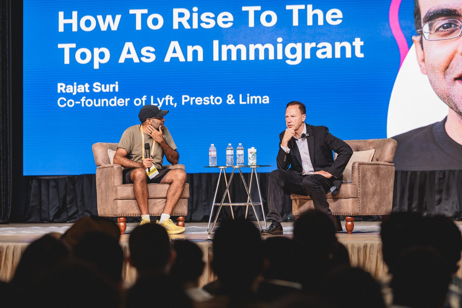 Rajat Suri on stage discussing rising to the top as an immigrant
